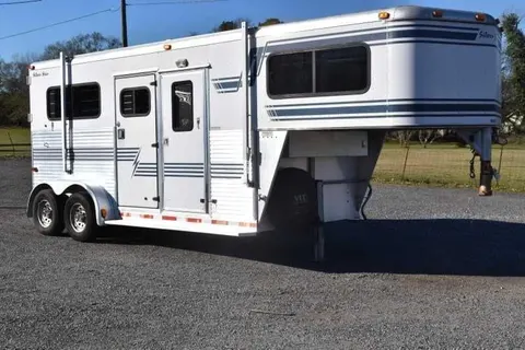 White two-horse gooseneck with blue striping, dressing room windows and twin rear doors